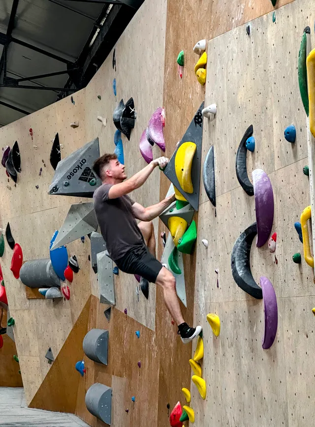 Alexandre on a climbing wall